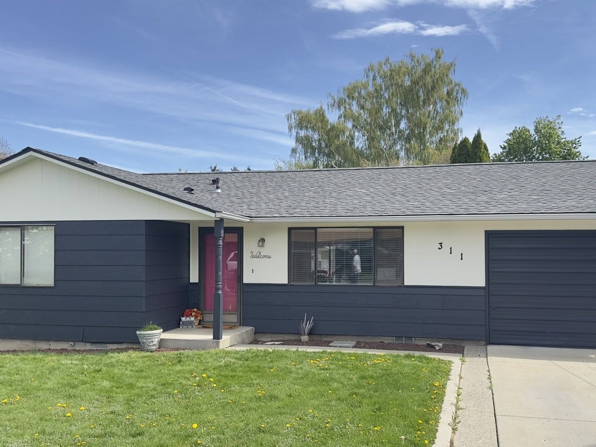 The same house after a full exterior repaint in navy
