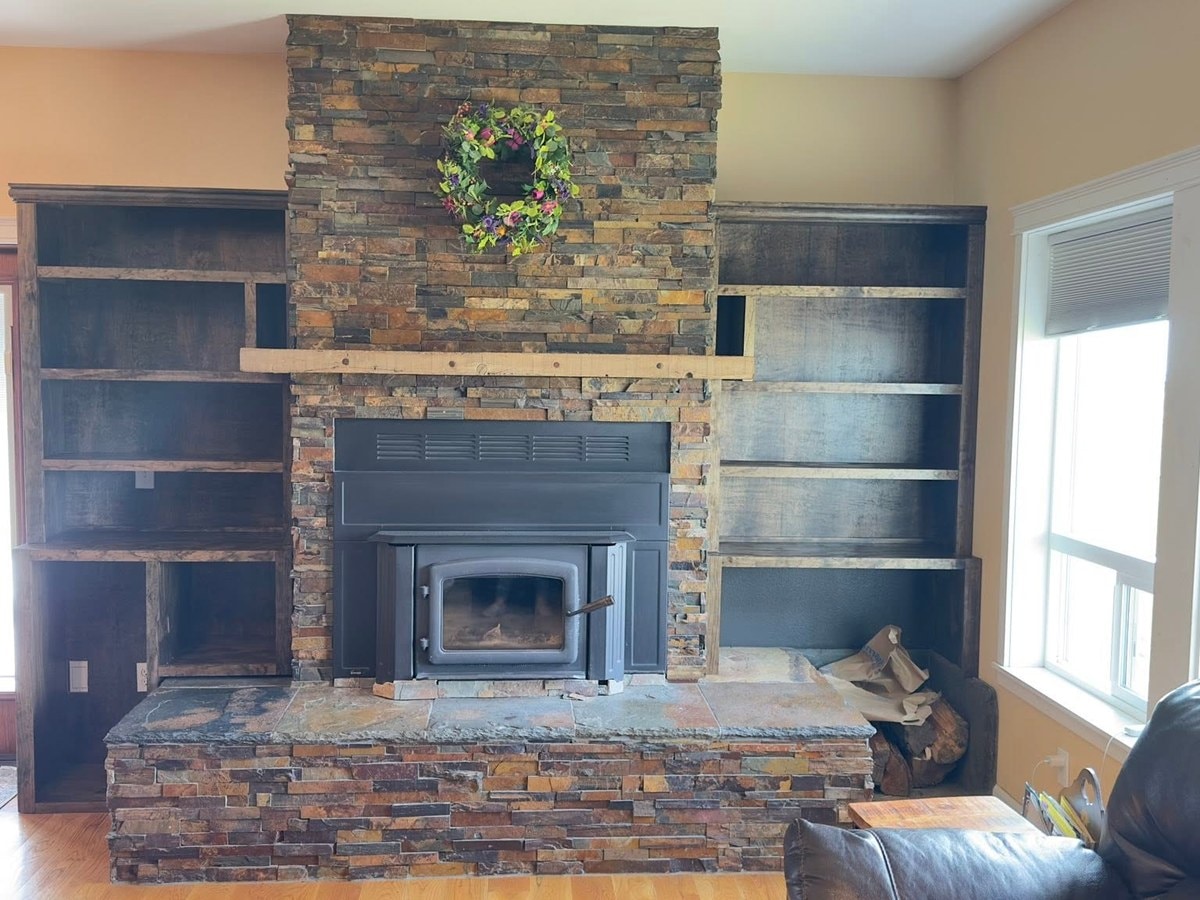 The fireplace after dark wood built-in shelving went in on both sides