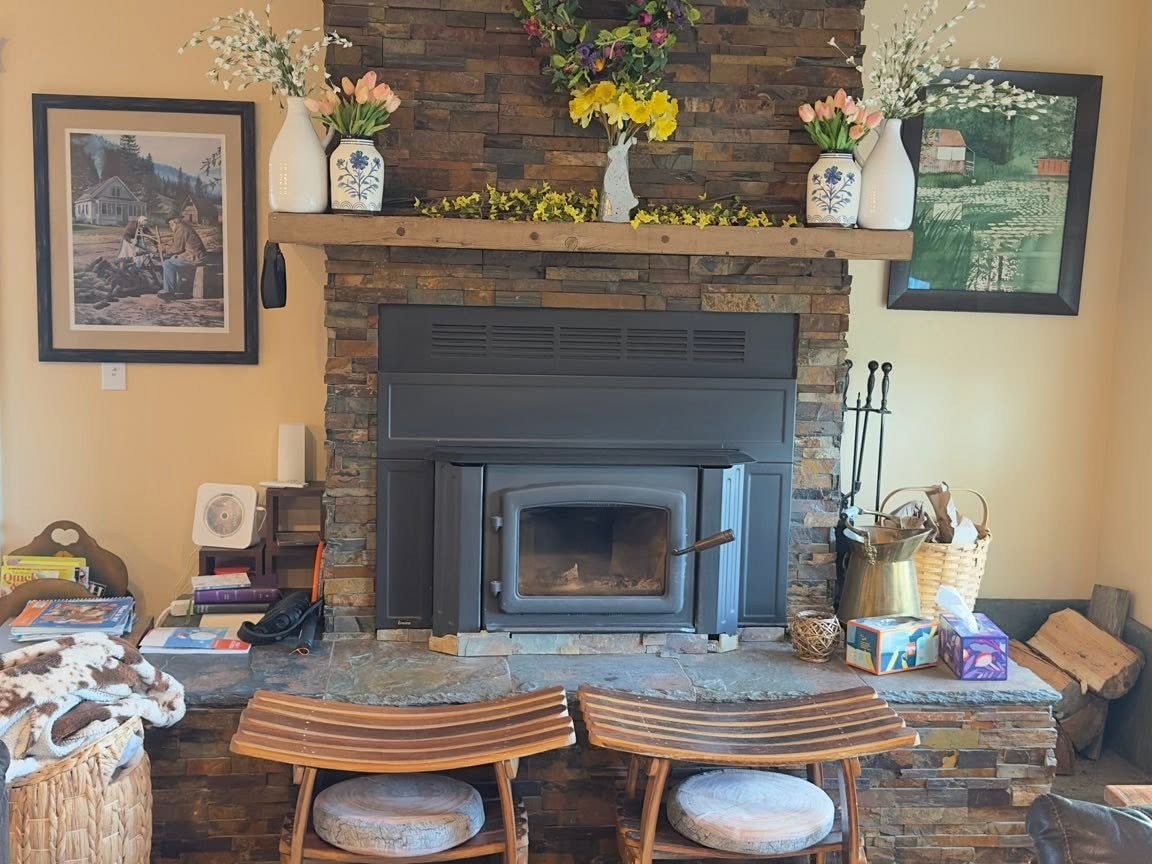 Stone fireplace with a plain mantel and no shelving