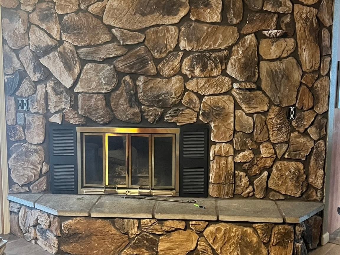 River rock fireplace surround before the rebuild
