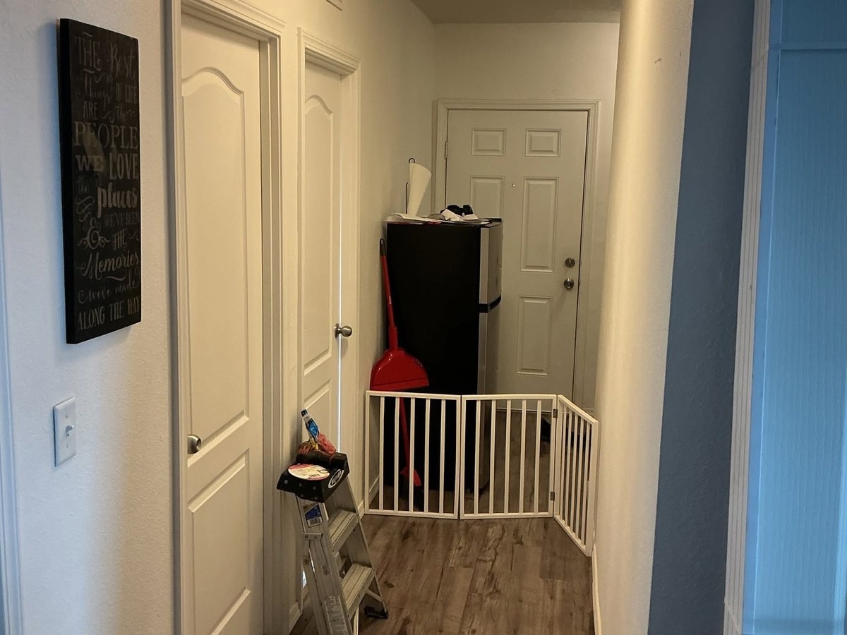 Open hallway running between two living spaces before the doorway went in