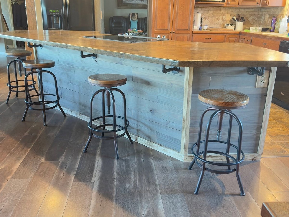 The rebuilt island brought down to one level with a wood counter and stools