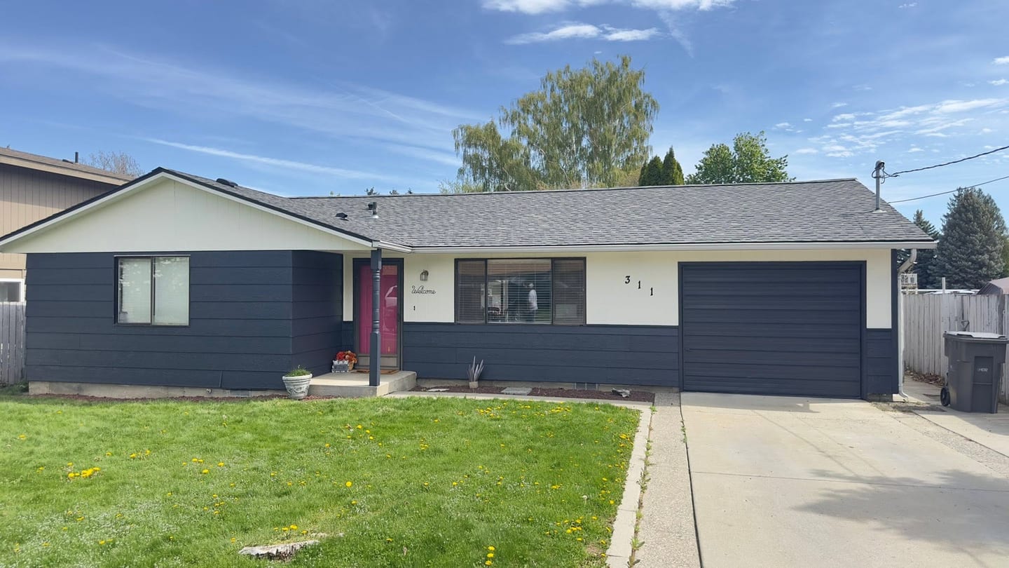 A repainted navy house exterior with attached garage