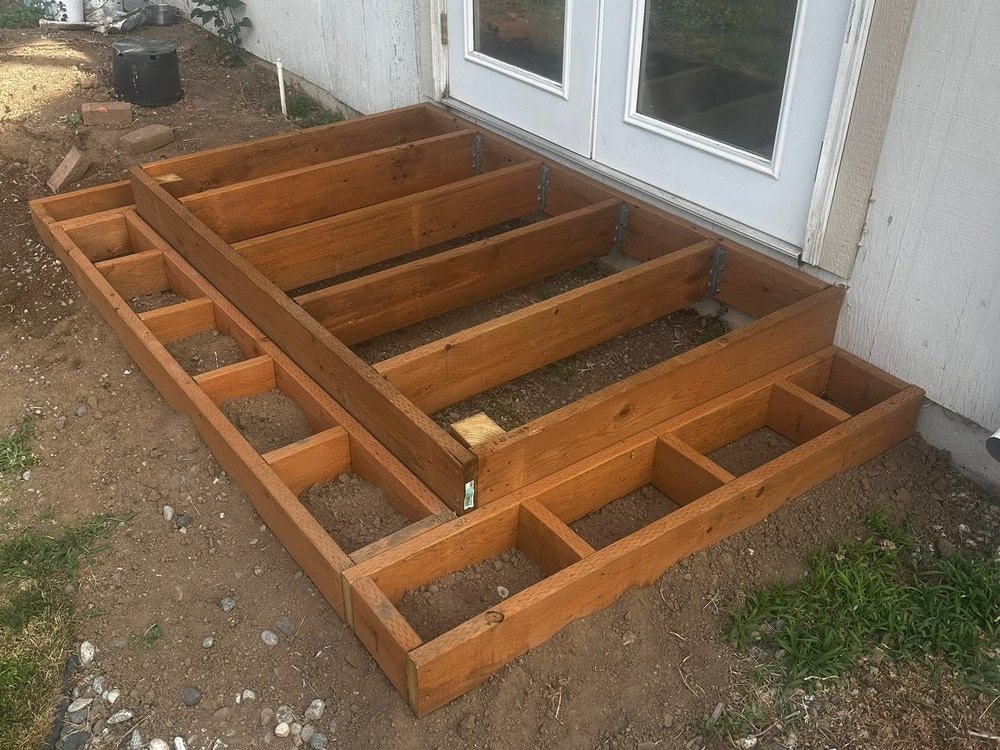 Looking down on the landing frame and step box laid out at the French doors