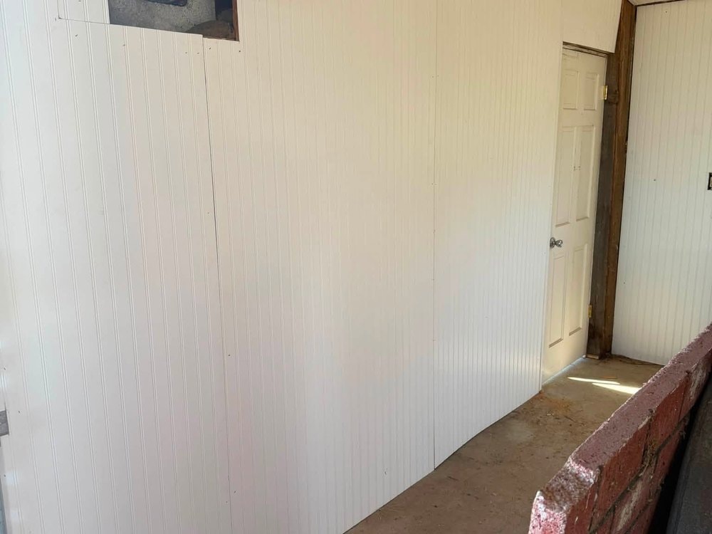 Paneled interior wall with the vent opening cut in near the roofline