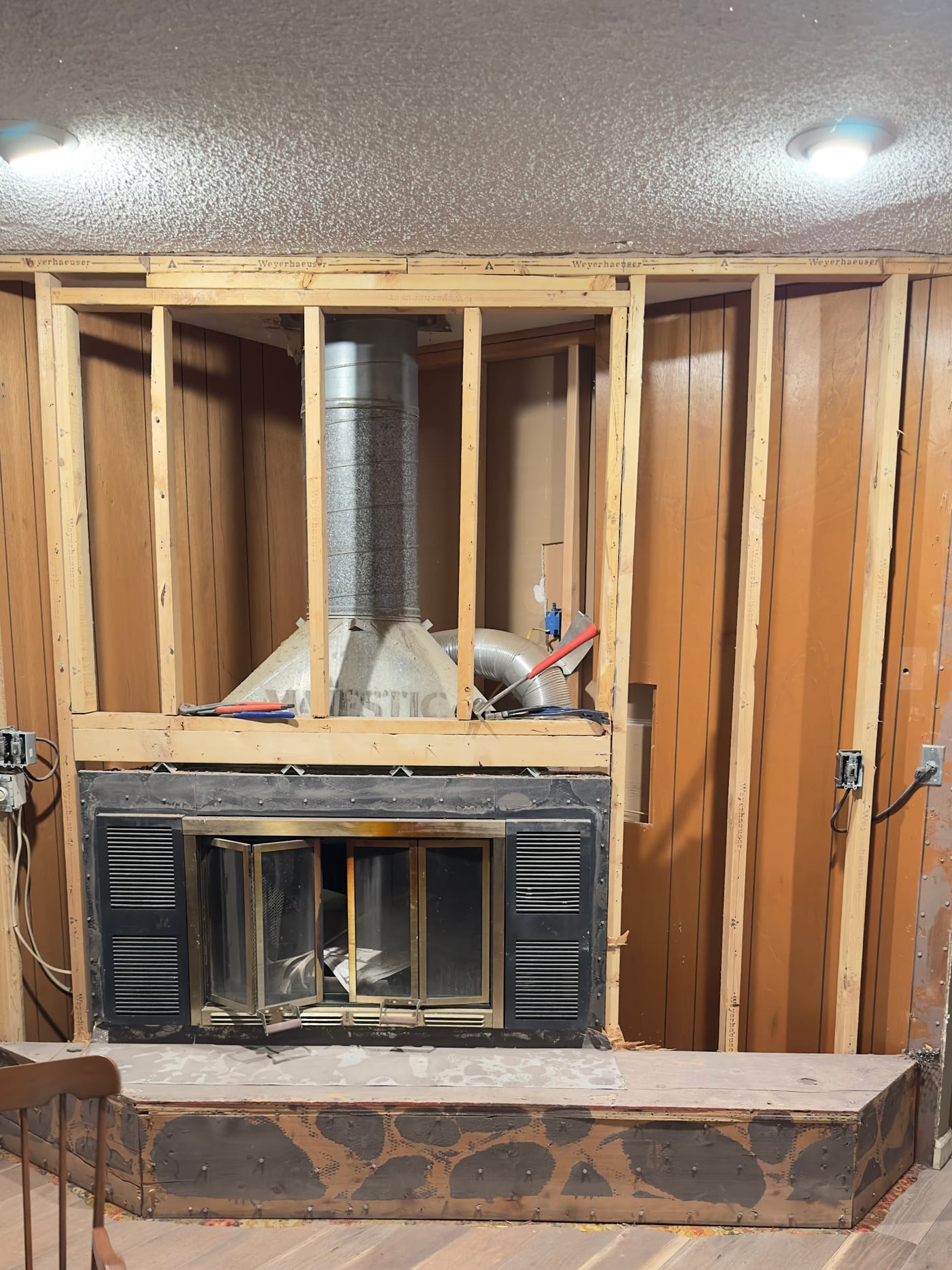 Alcoves framed either side of the fireplace ready for built-in shelving