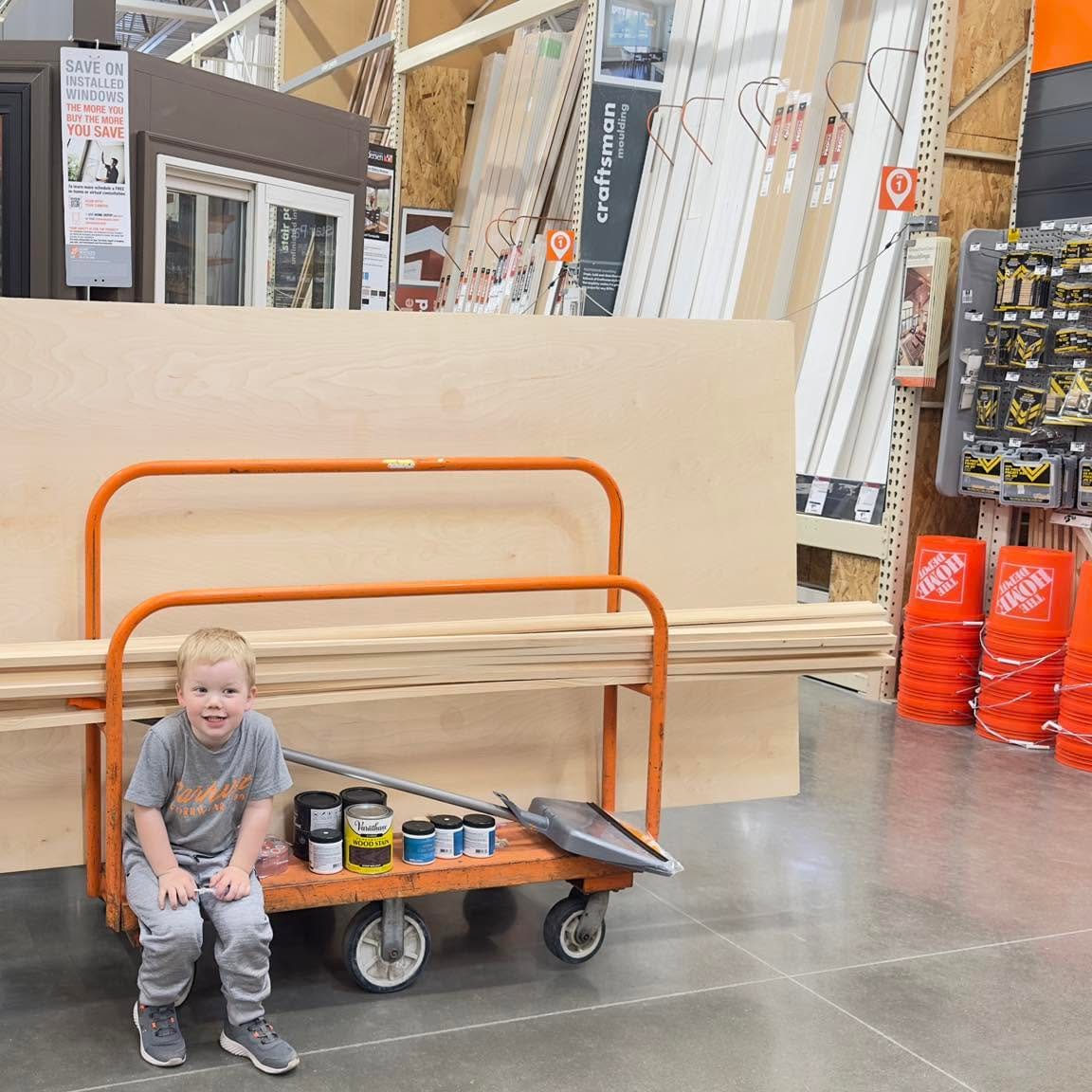 The Kyzars' youngest riding a lumber cart on a supply run