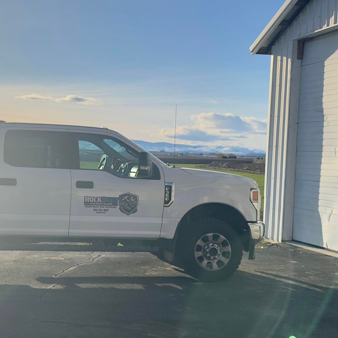 The RockBuilt work truck parked at sunrise before a job
